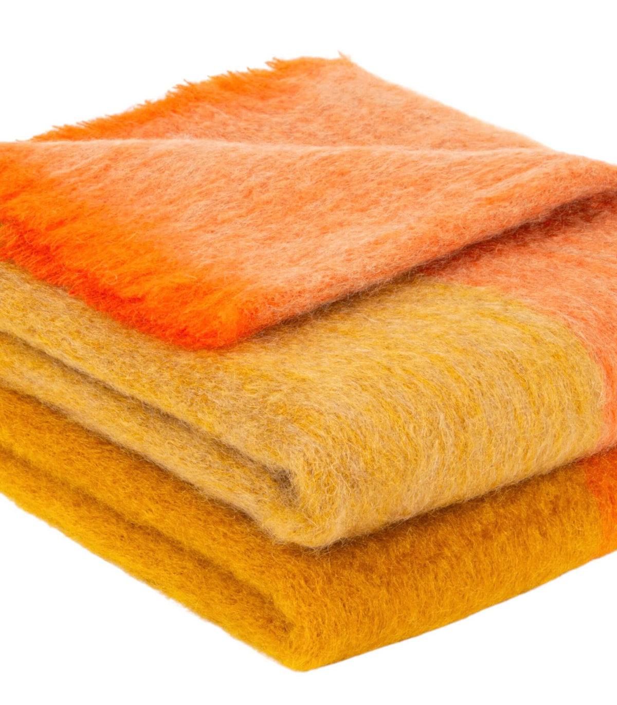 Détail des nuances orange, abricot et miel sur plaid en mohair